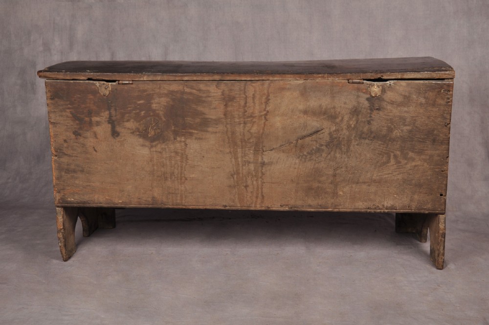 A Tudor era dark oak coffer featuring four carved linenfold panels and an iron lockplate on the front facade. View XV