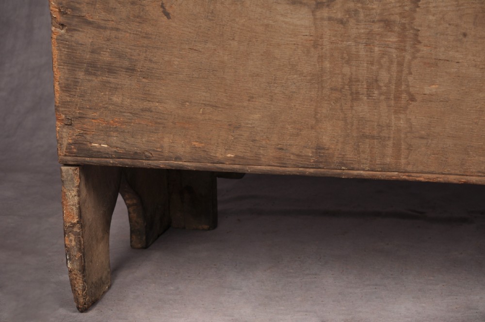 A Tudor era dark oak coffer featuring four carved linenfold panels and an iron lockplate on the front facade. View XVI