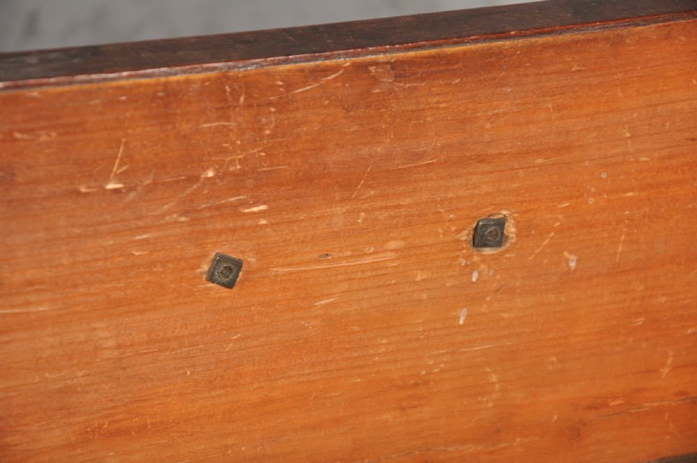 An 18th-century mahogany chest of drawers featuring two short over three long graduated drawers, carved blind fretwork stiles, brass swan-neck handles, and ogee bracket feet. View VIII