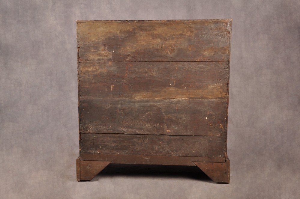 An early eighteenth-century walnut bureau with a sloping fall front, four drawers, decorative brass handles, and bracket feet. View XIV