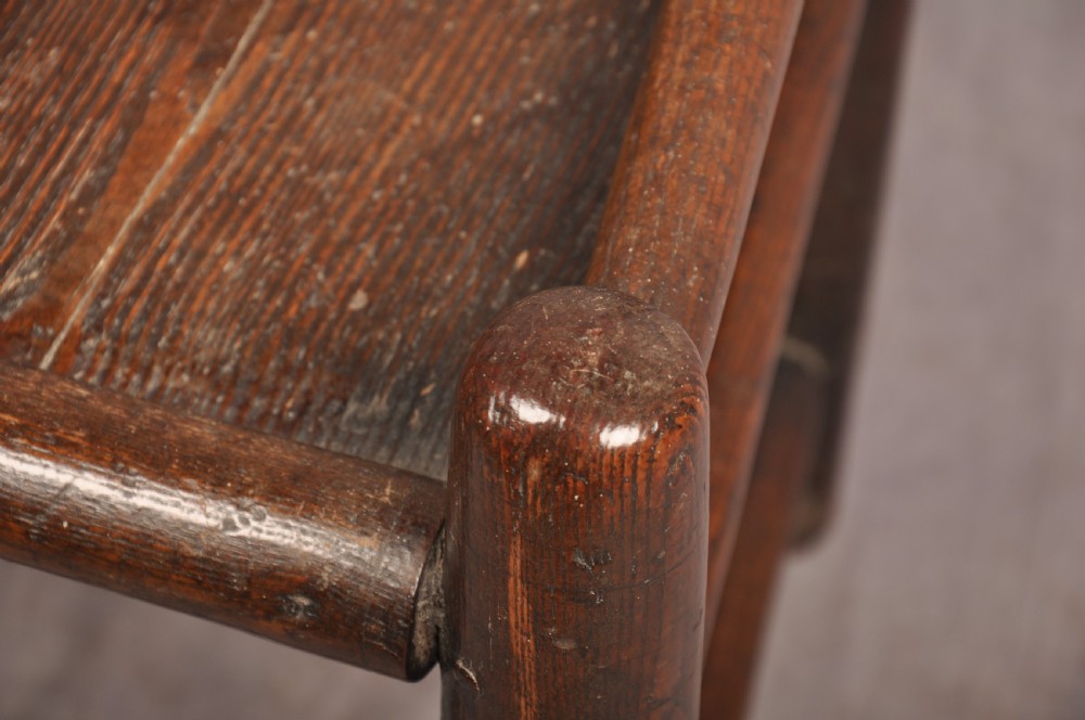 A near pair of dark 17th-century turned ash chairs with spindle backrests, turned stretchers, panel seats, and top finials. View III