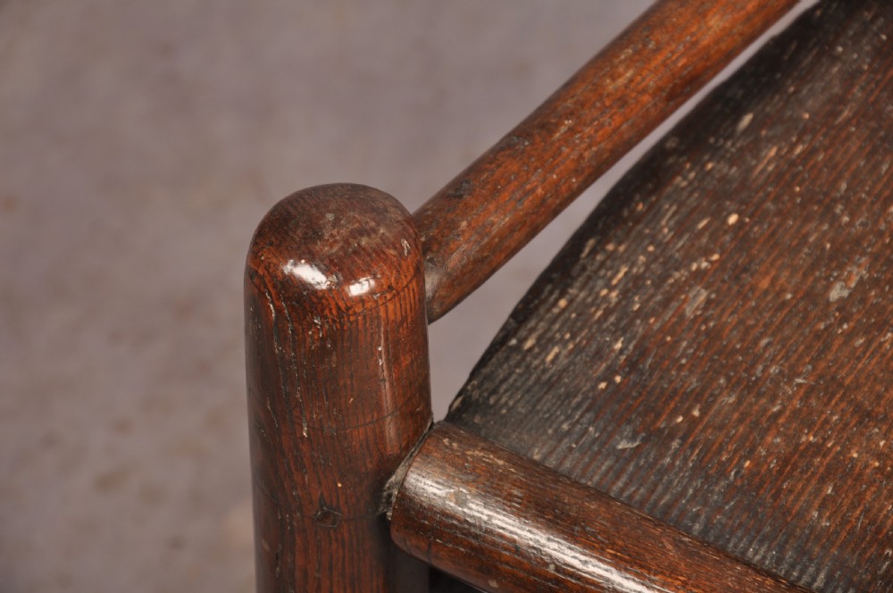 A near pair of dark 17th-century turned ash chairs with spindle backrests, turned stretchers, panel seats, and top finials. View IV