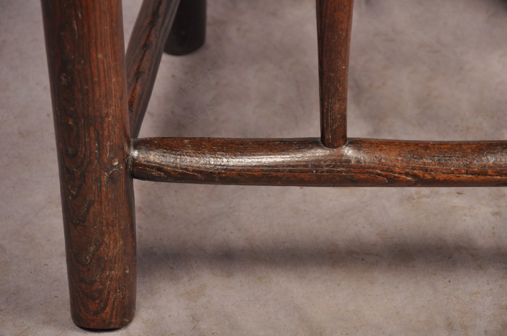 A near pair of dark 17th-century turned ash chairs with spindle backrests, turned stretchers, panel seats, and top finials. View VIII