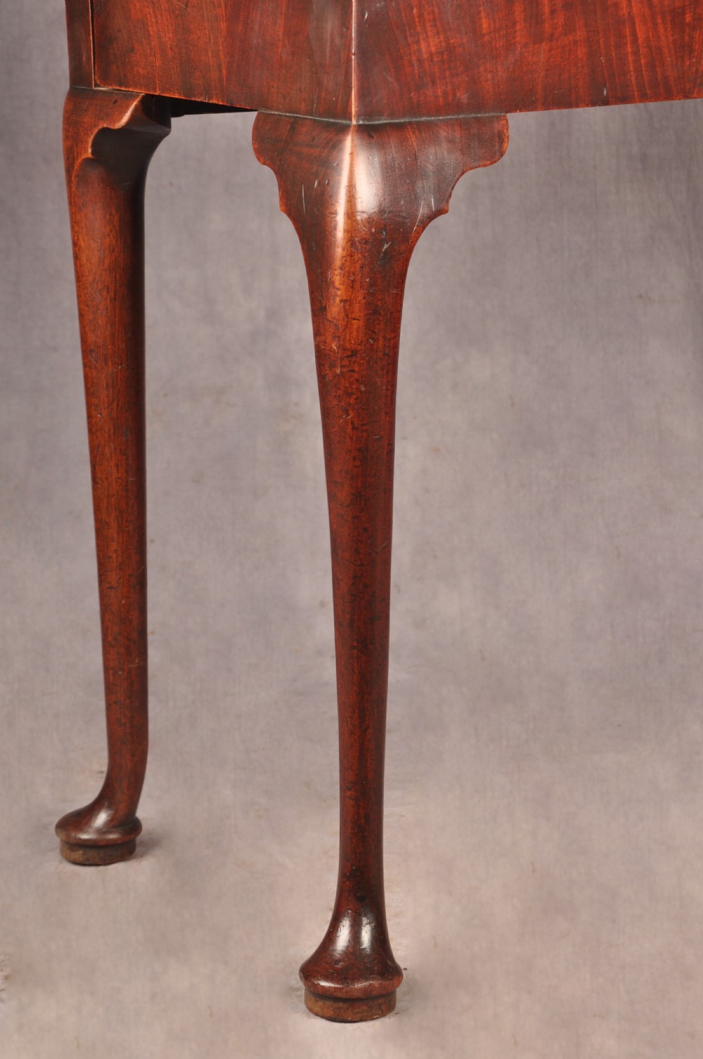 An 18th-century mahogany triple-top card table resting on four cabriole legs with pad feet. View II