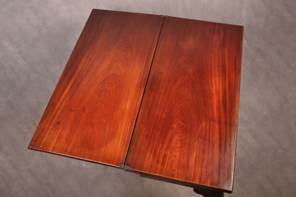 An 18th-century mahogany triple-top card table resting on four cabriole legs with pad feet. View VII