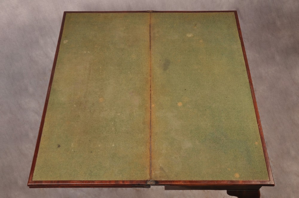 An 18th-century mahogany triple-top card table resting on four cabriole legs with pad feet. View VIII
