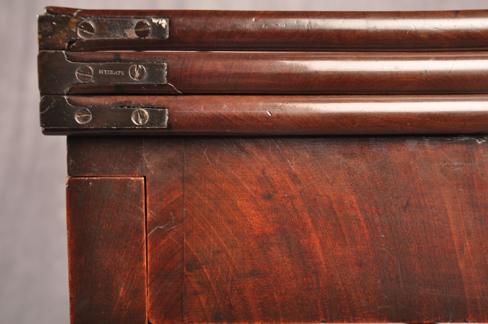 An 18th-century mahogany triple-top card table resting on four cabriole legs with pad feet. View X