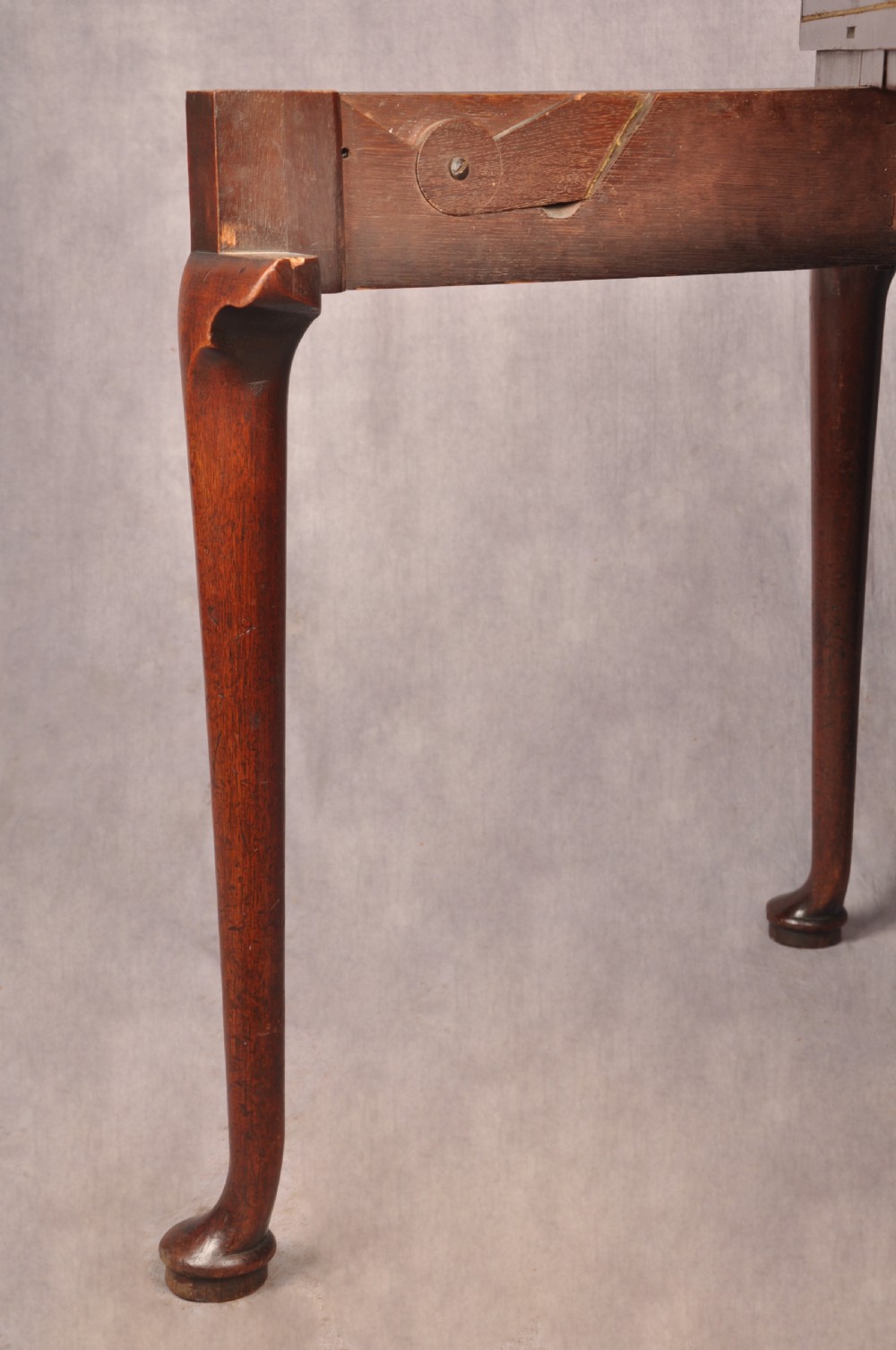 An 18th-century mahogany triple-top card table resting on four cabriole legs with pad feet. View XI