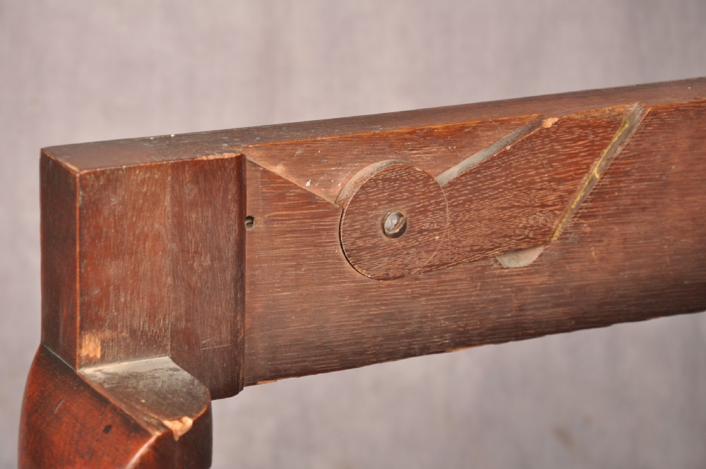An 18th-century mahogany triple-top card table resting on four cabriole legs with pad feet. View XII