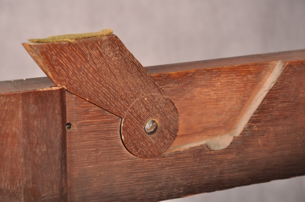 An 18th-century mahogany triple-top card table resting on four cabriole legs with pad feet. View XIII