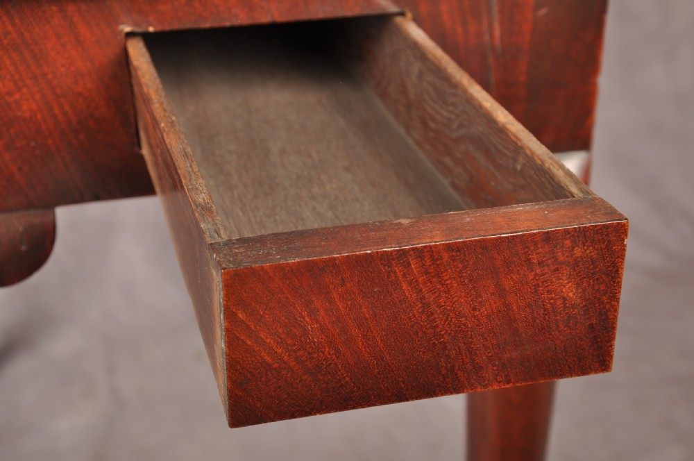 An 18th-century mahogany triple-top card table resting on four cabriole legs with pad feet. View XVI