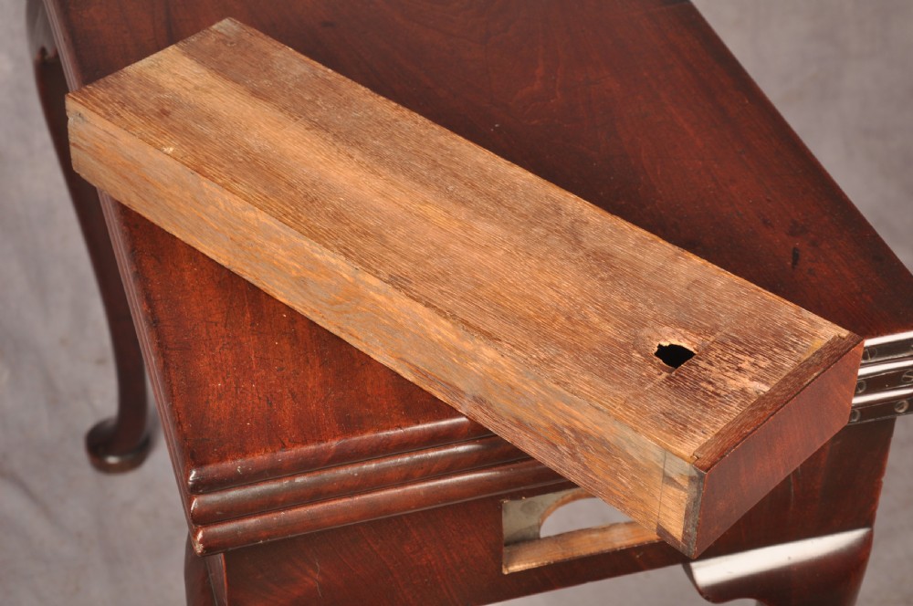 An 18th-century mahogany triple-top card table resting on four cabriole legs with pad feet. View XVII