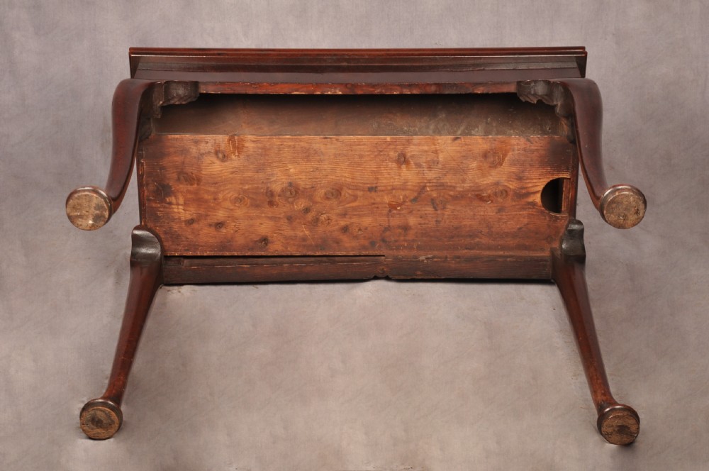 An 18th-century mahogany triple-top card table resting on four cabriole legs with pad feet. View XX