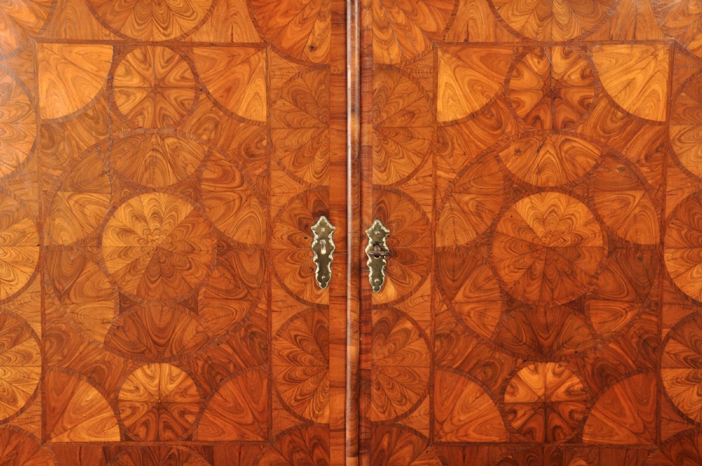 A seventeenth-century kingwood cabinet on stand featuring geometric oyster parquetry doors, a single frieze drawer, six barley twist legs, and a shaped stretcher. View V