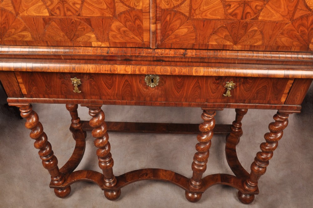 A seventeenth-century kingwood cabinet on stand featuring geometric oyster parquetry doors, a single frieze drawer, six barley twist legs, and a shaped stretcher. View VII