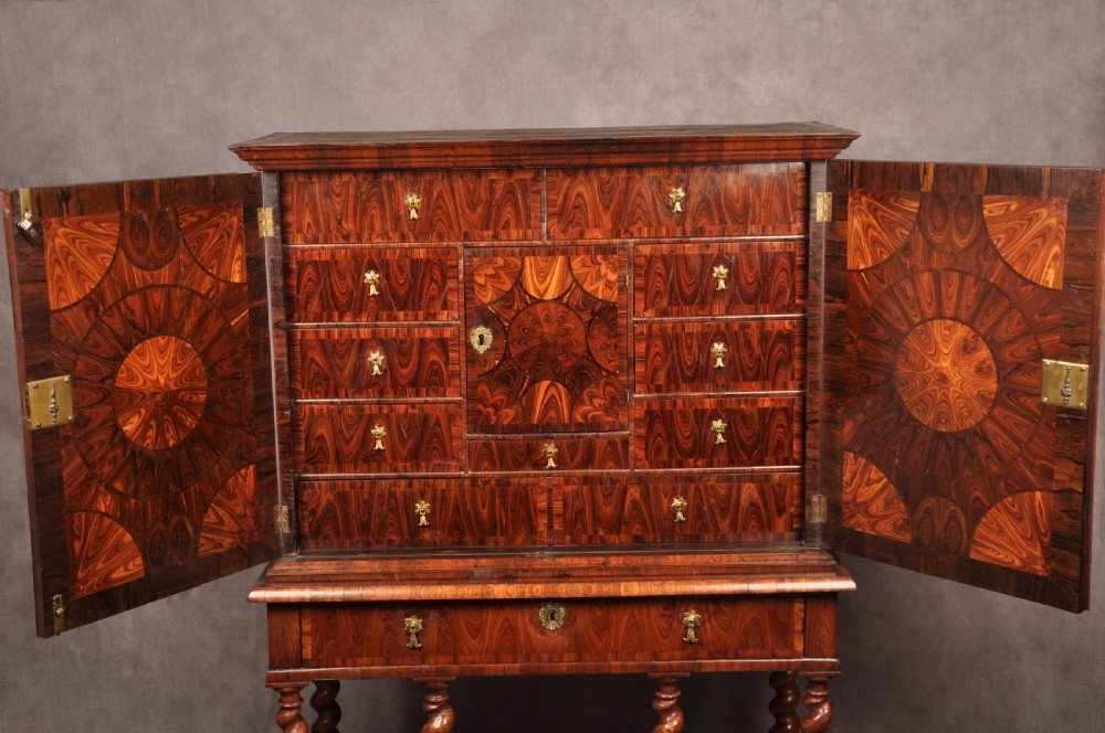 A seventeenth-century kingwood cabinet on stand featuring geometric oyster parquetry doors, a single frieze drawer, six barley twist legs, and a shaped stretcher. View VIII
