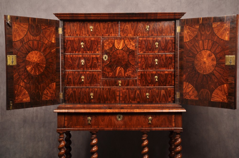 A seventeenth-century kingwood cabinet on stand featuring geometric oyster parquetry doors, a single frieze drawer, six barley twist legs, and a shaped stretcher. View IX