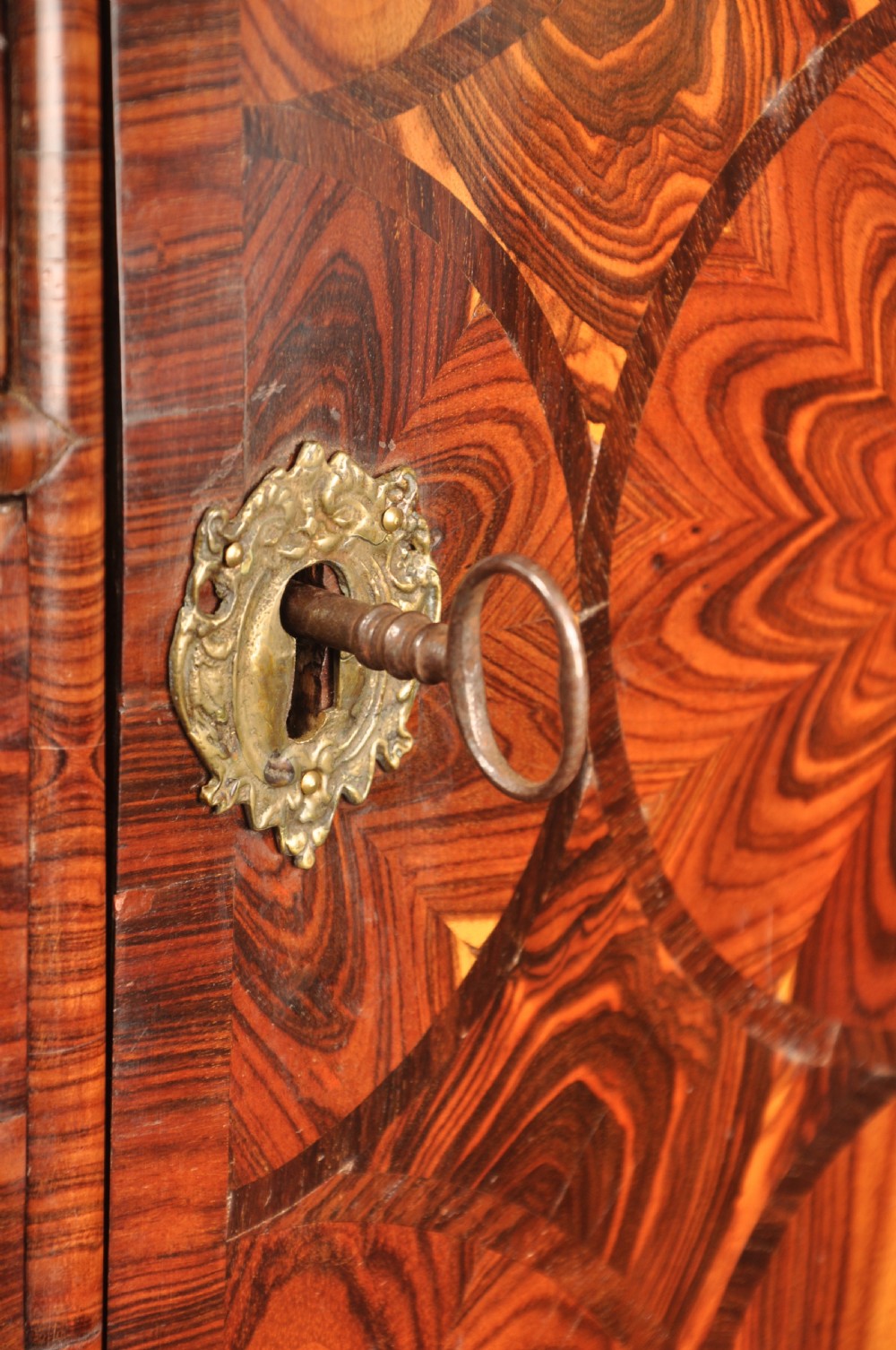 A seventeenth-century kingwood cabinet on stand featuring geometric oyster parquetry doors, a single frieze drawer, six barley twist legs, and a shaped stretcher. View XV