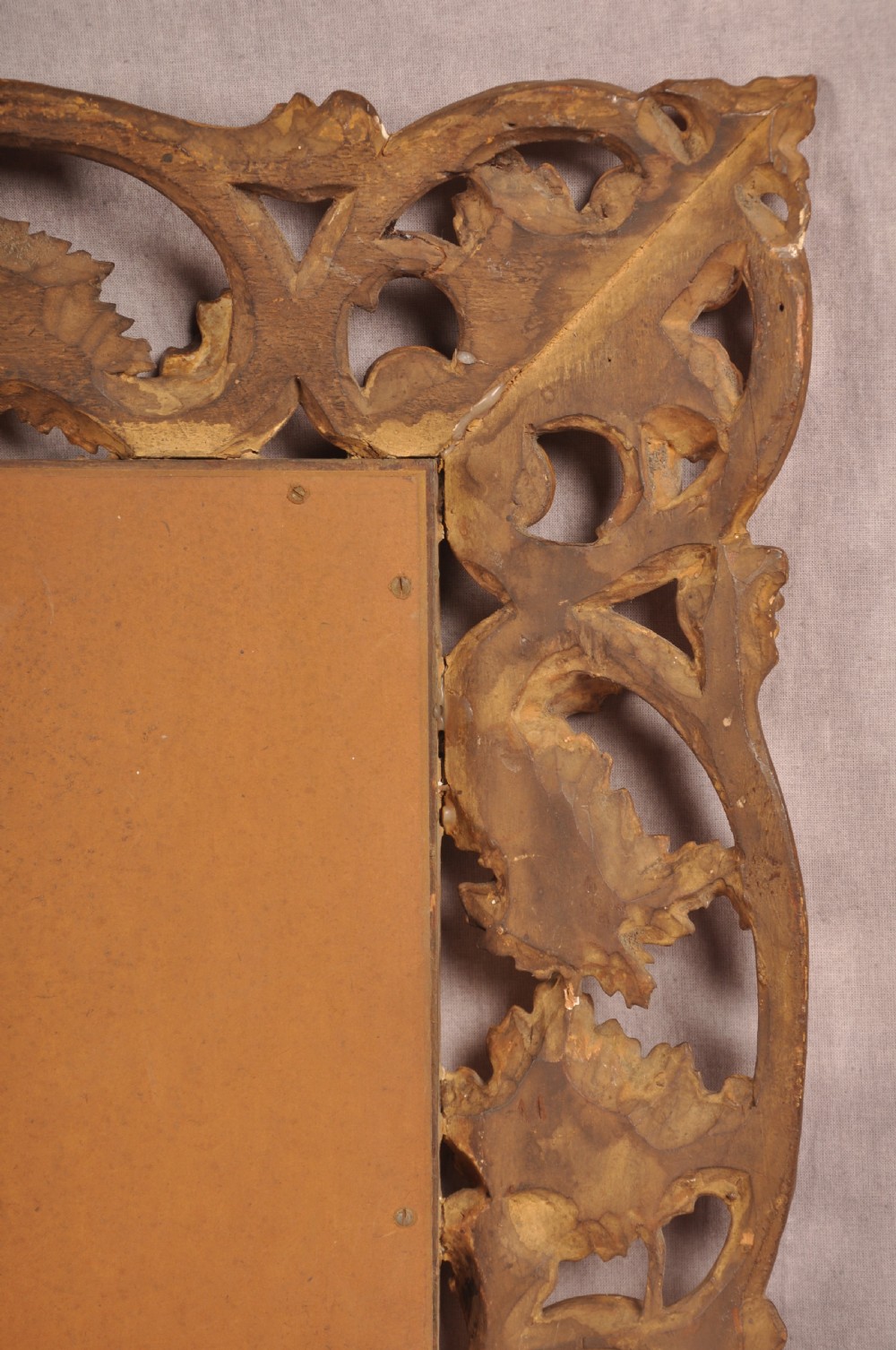 An early nineteenth-century rectangular wall mirror set within a deeply carved Florentine giltwood frame featuring openwork foliage, scrolls, and a beaded inner edge. View IX