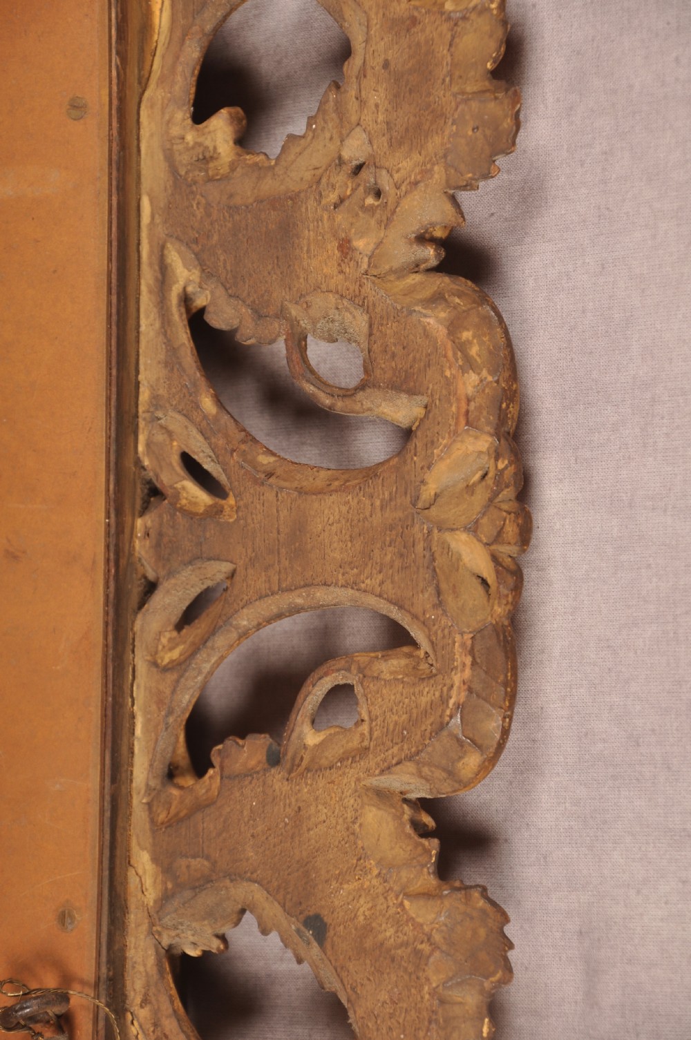 An early nineteenth-century rectangular wall mirror set within a deeply carved Florentine giltwood frame featuring openwork foliage, scrolls, and a beaded inner edge. View X