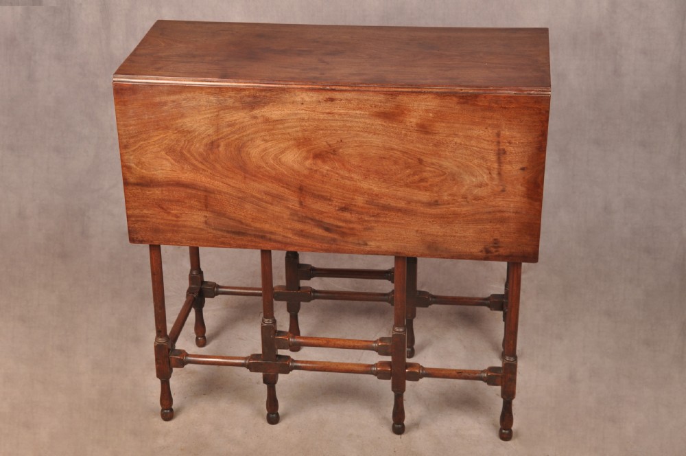 An 18th-century mahogany drop-leaf spider table featuring slender turned legs, cross stretchers, and two fold-out side flaps. View II