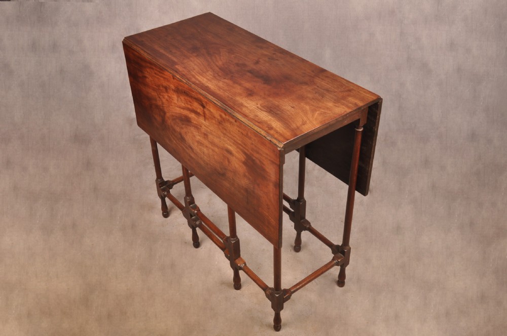 An 18th-century mahogany drop-leaf spider table featuring slender turned legs, cross stretchers, and two fold-out side flaps. View III