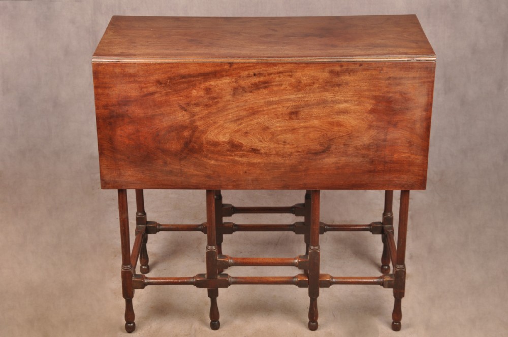 An 18th-century mahogany drop-leaf spider table featuring slender turned legs, cross stretchers, and two fold-out side flaps. View IV