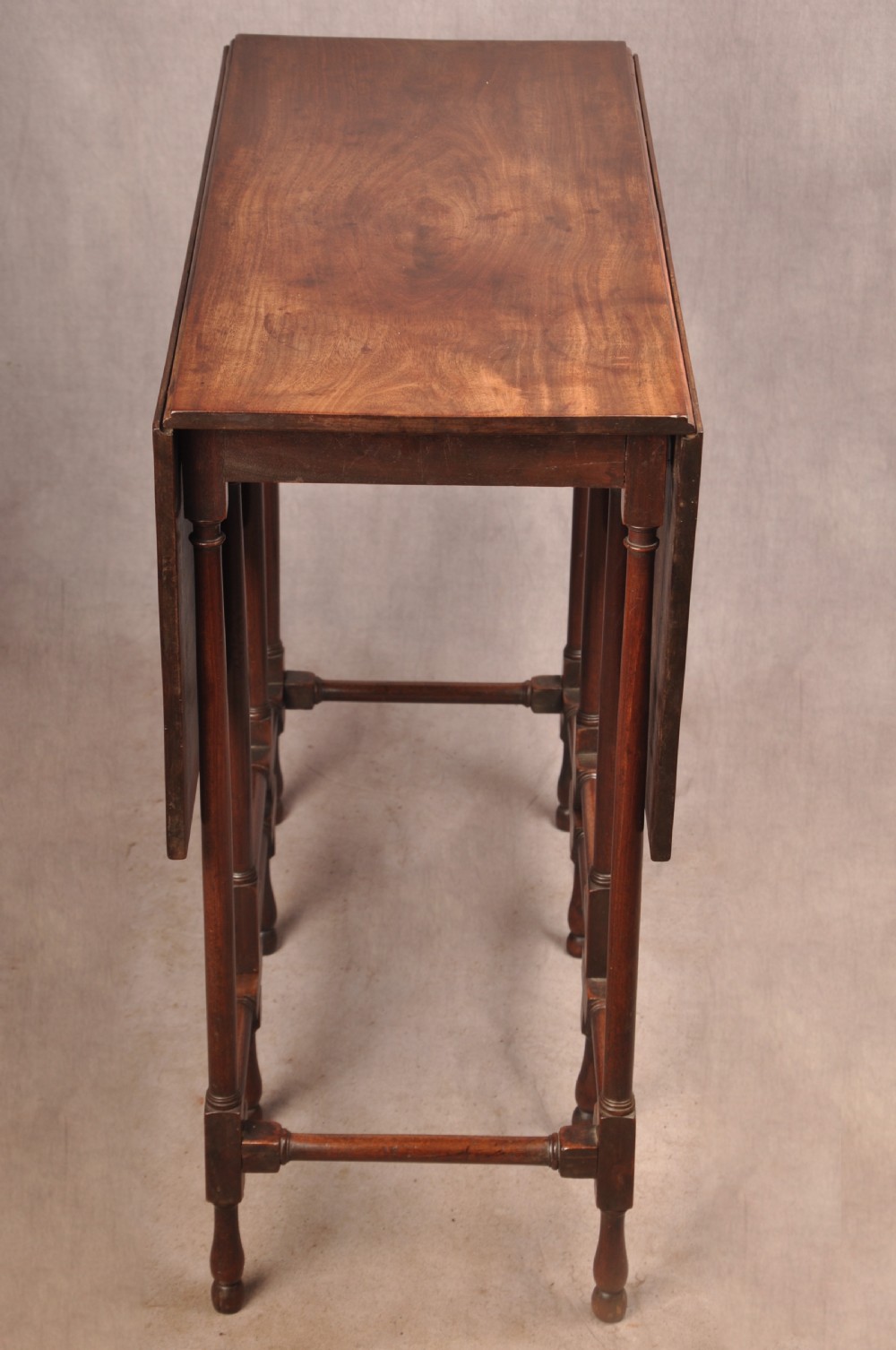 An 18th-century mahogany drop-leaf spider table featuring slender turned legs, cross stretchers, and two fold-out side flaps. View VI