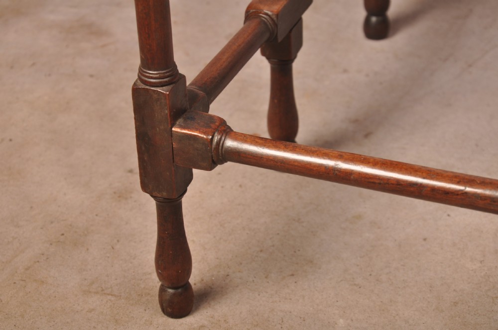 An 18th-century mahogany drop-leaf spider table featuring slender turned legs, cross stretchers, and two fold-out side flaps. View VIII