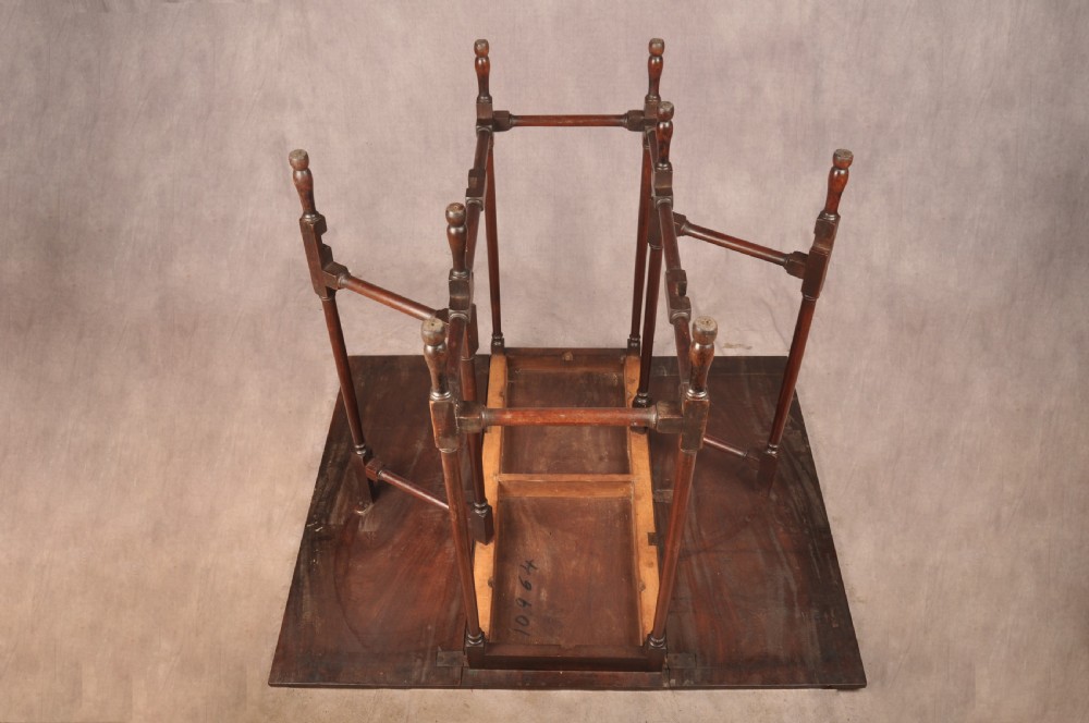 An 18th-century mahogany drop-leaf spider table featuring slender turned legs, cross stretchers, and two fold-out side flaps. View XI