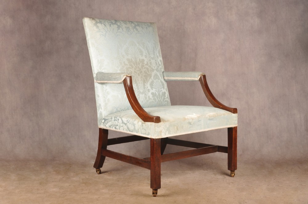 An eighteenth-century mahogany Gainsborough library armchair upholstered in pale blue damask fabric with brass castors.