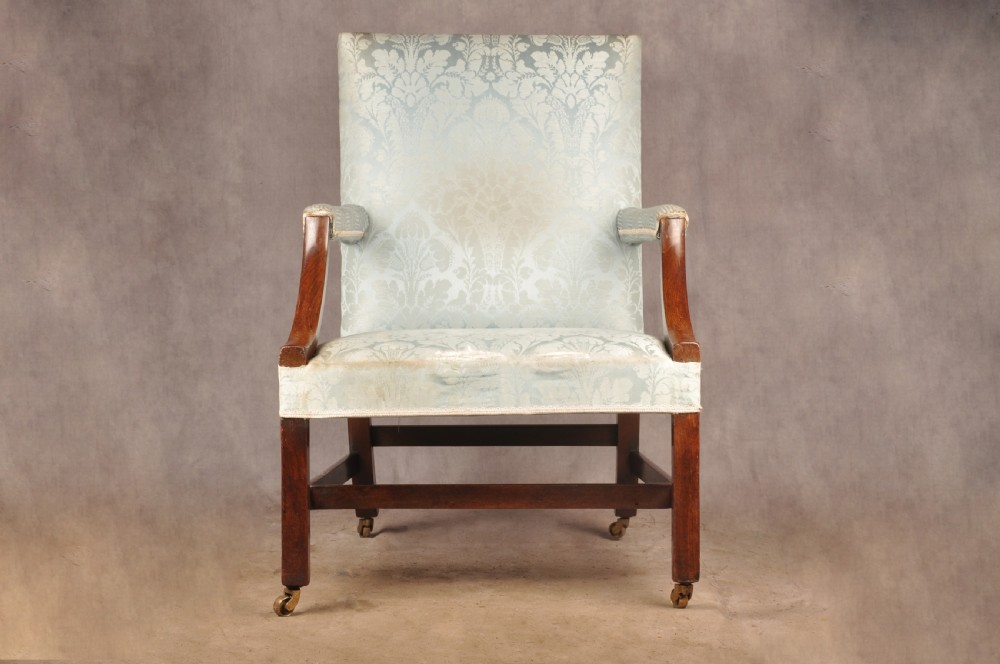 An eighteenth-century mahogany Gainsborough library armchair upholstered in pale blue damask fabric with brass castors. View II
