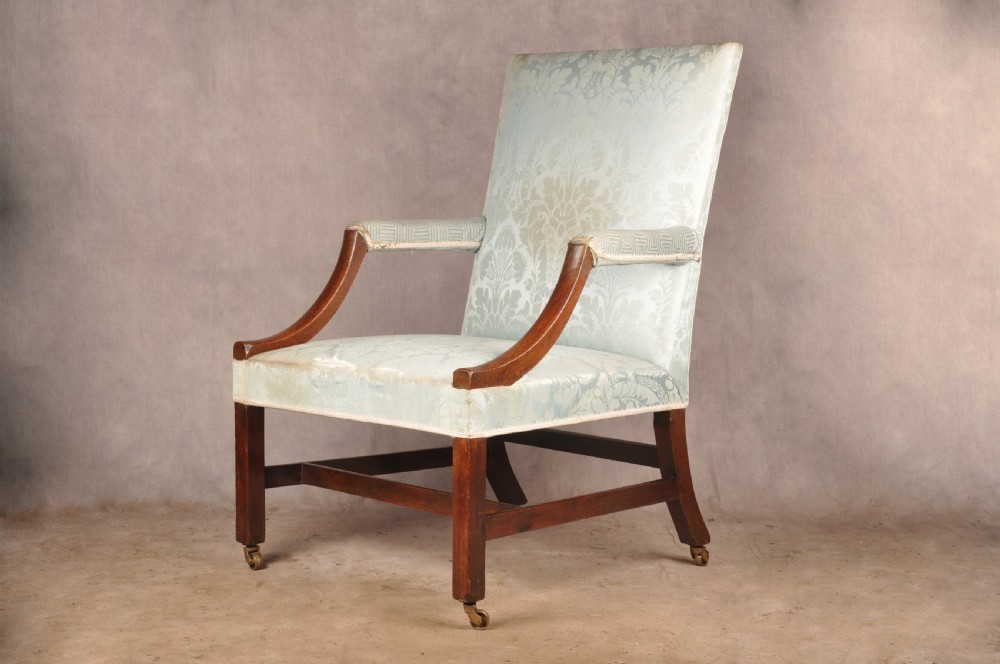 An eighteenth-century mahogany Gainsborough library armchair upholstered in pale blue damask fabric with brass castors. View III