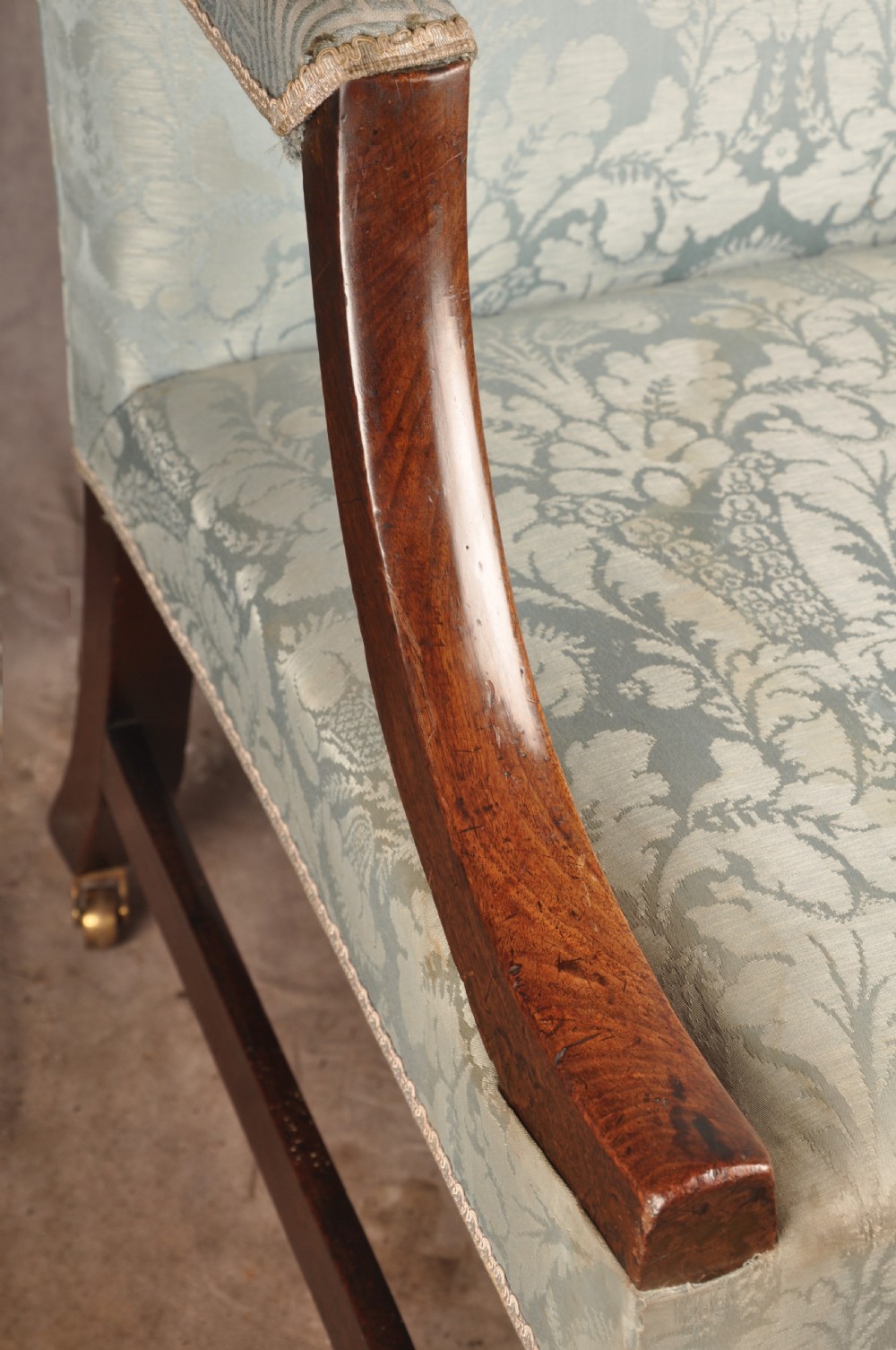 An eighteenth-century mahogany Gainsborough library armchair upholstered in pale blue damask fabric with brass castors. View VI