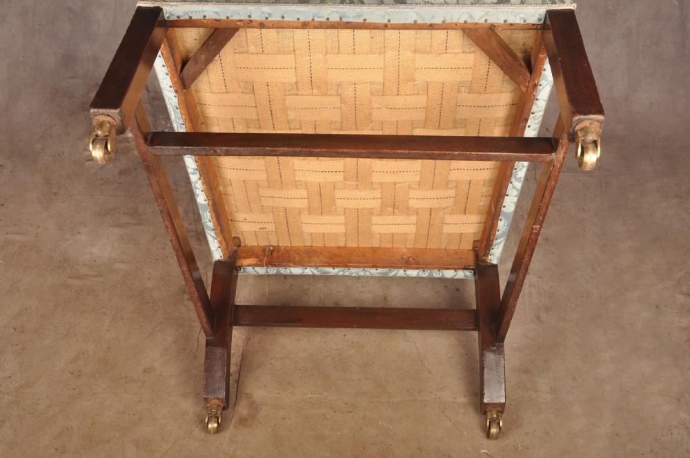 An eighteenth-century mahogany Gainsborough library armchair upholstered in pale blue damask fabric with brass castors. View VIII