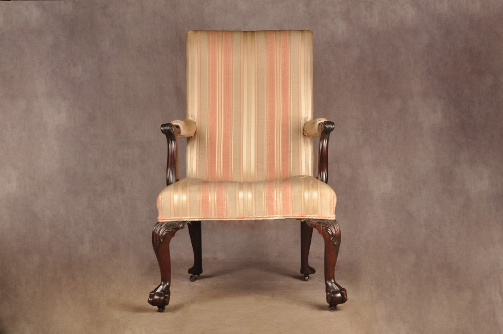 An 18th-century mahogany library chair upholstered in striped pink and cream fabric, featuring hand-carved cabriole front legs with ball-and-claw feet. View II