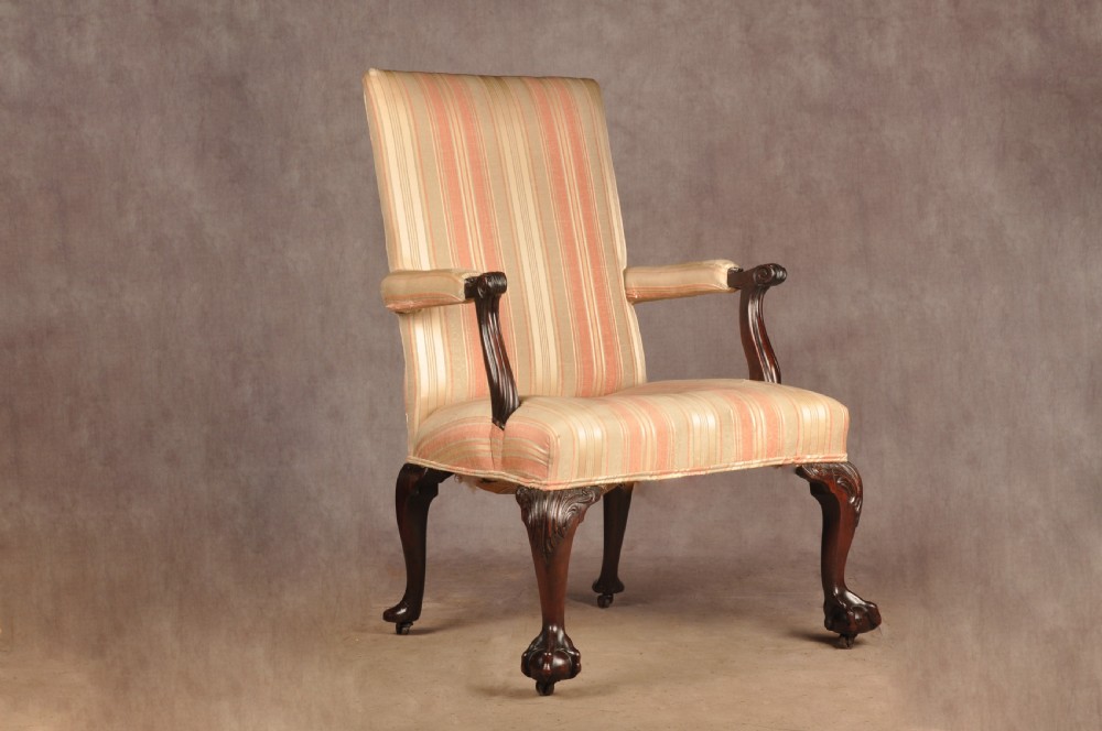 An 18th-century mahogany library chair upholstered in striped pink and cream fabric, featuring hand-carved cabriole front legs with ball-and-claw feet. View III