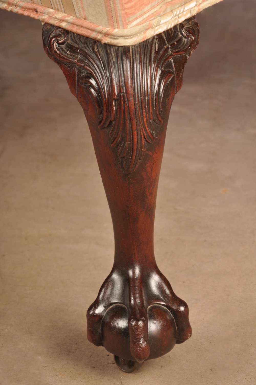 An 18th-century mahogany library chair upholstered in striped pink and cream fabric, featuring hand-carved cabriole front legs with ball-and-claw feet. View VIII