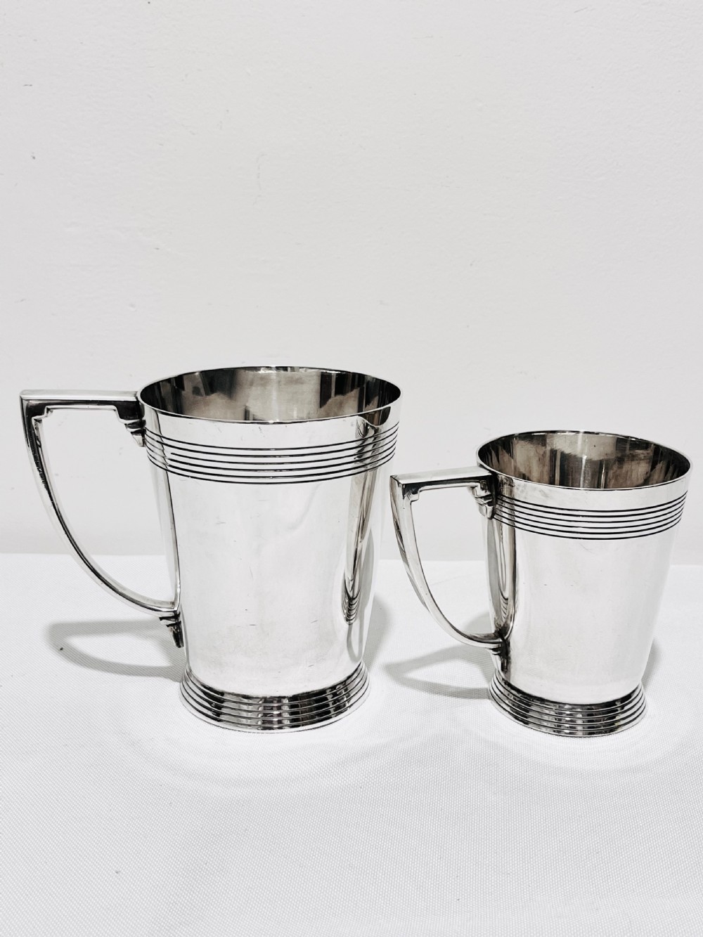 A handsome pair of tankards designed by Keith Murray for Mappin & Webb c1930