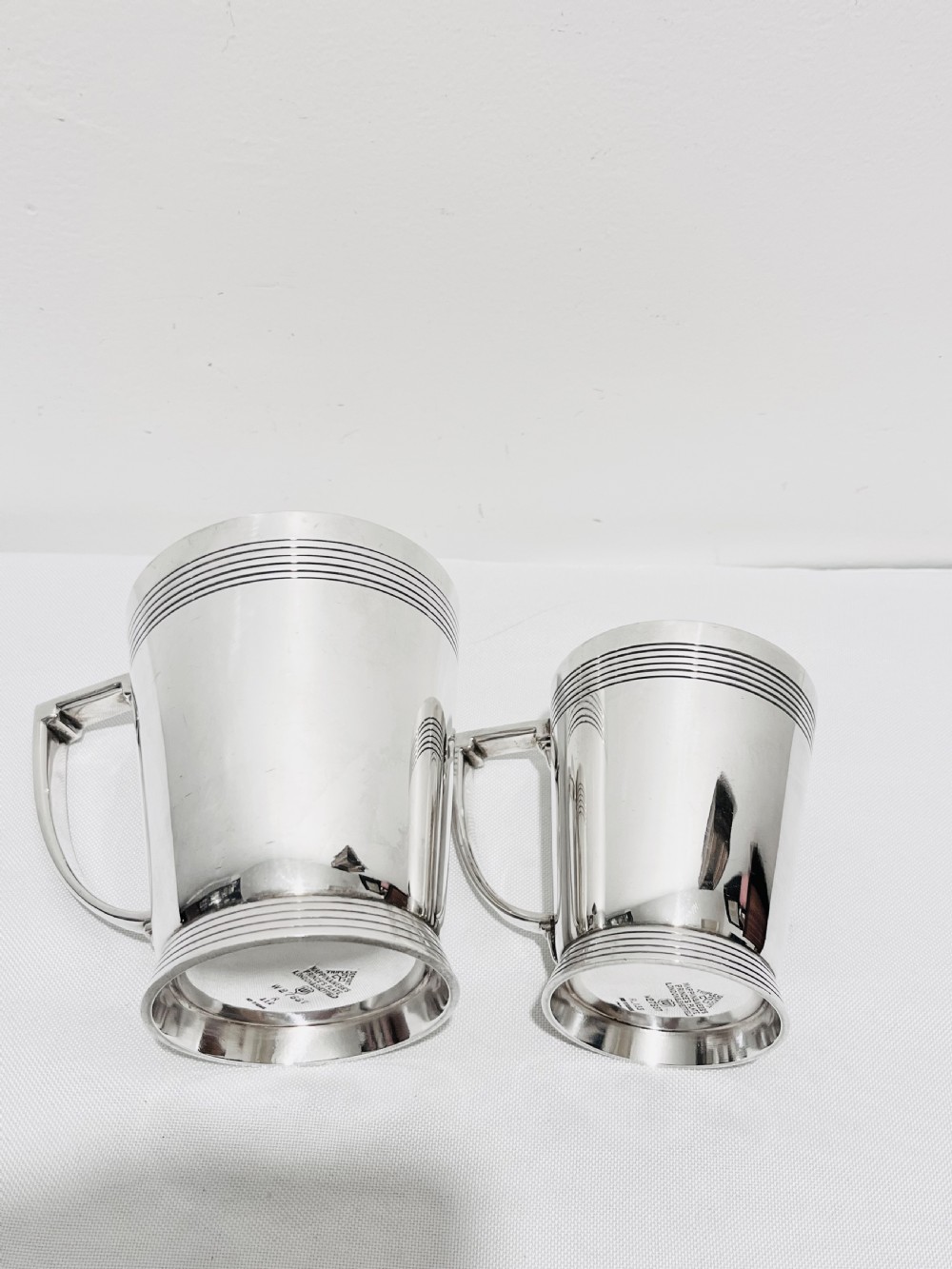 A handsome pair of tankards designed by Keith Murray for Mappin & Webb c1930 View V