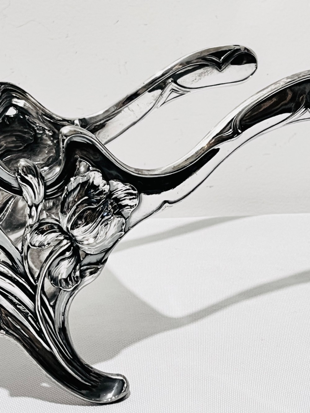 An Art Nouveau silver-plated wine wagon shaped like a stylized wheelbarrow with intricate botanical openwork and flowing organic curves. View III
