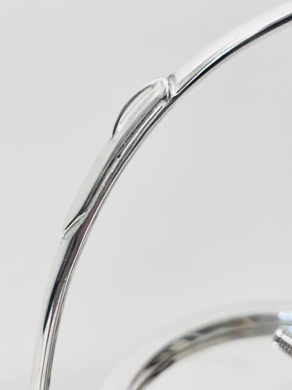 A drum-shaped antique oak biscuit box featuring silver-plated rims, rope cord detail, crossed drumstick lid finial, and a silver swing handle. View VI