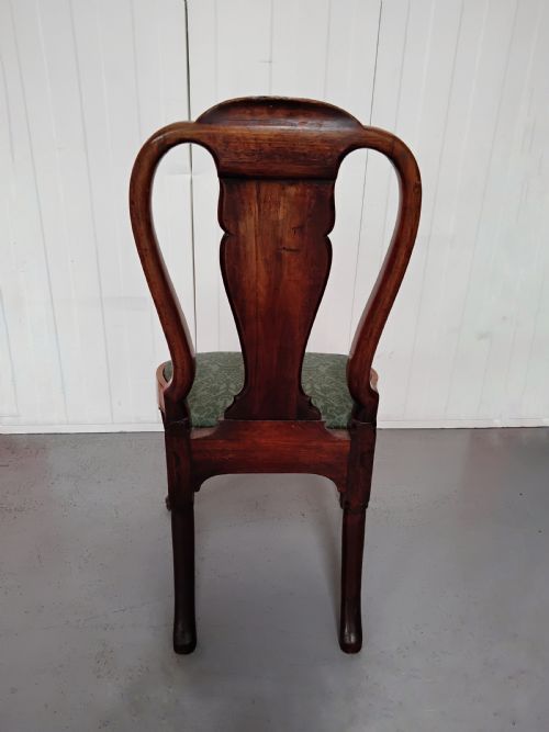 fig 1. An antique Queen Anne walnut side chair featuring a vase-shaped splat back, green patterned drop-in seat, and carved cabriole legs with pad feet.