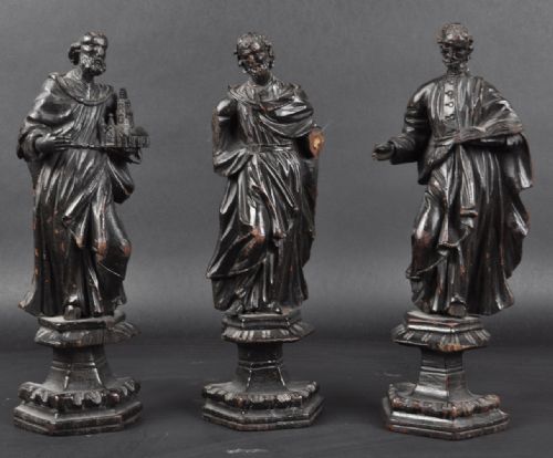 A Group of Three 
C17th Carved Wood Saints on Stands