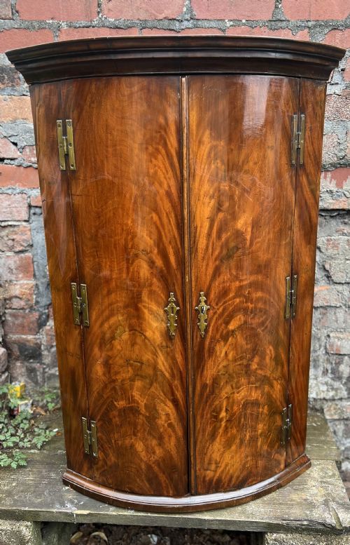 George III Flame Mahogany Bow Fronted Corner Cupboard