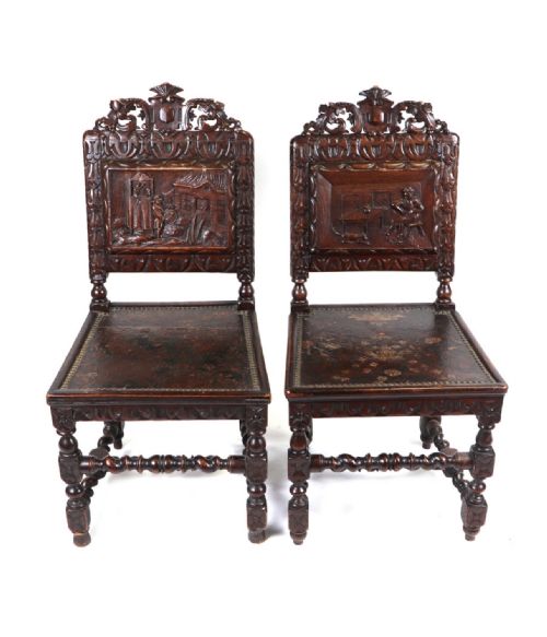 A Pair of Black Forest Manner Carved Chairs with a Carved Panel Depicting a Dancing Bear Show