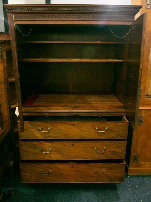 fig 1. George III mahogany linen press with faux drawers to the top