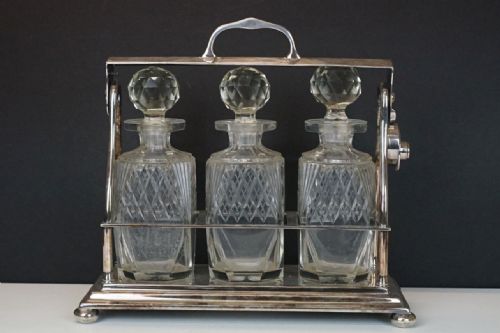 Early C20th Silver Plated Tantalus with Three Bottles
