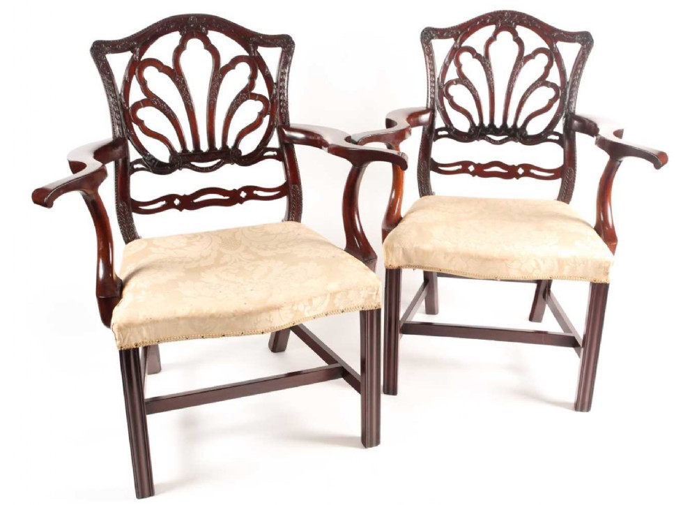 Georgian pair of armchairs with carved backs and out swept arms 