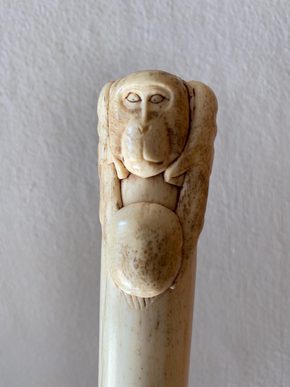C19th Chinese bone walking stick with carved monkey holding a ball 